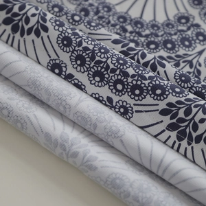 Close-up of thick cotton canvas tablecloth showing blue floral mandala patterns
