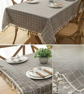 Detail of grey plaid table cloth with elegant white tassels on thick blended fabric