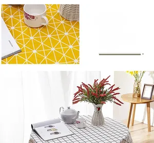 Detailed close-up of Scandinavian style tablecloth with white grid and tassel accents