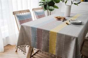 Detail of Nordic style patchwork plaid table runner with handmade cotton linen tassels