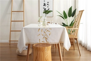 Detailed embroidery of yellow leaf patterns and lace edge on minimalist waterproof tablecloth