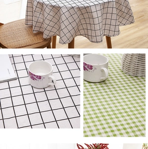 Detail of plaid cotton linen tablecloth with fringe tassels in black and green patterns