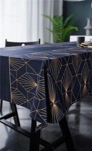 Close-up of luxury dark blue velvet tablecloth with gold geometric art deco pattern