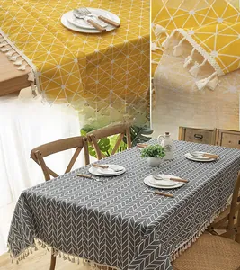 Close-up of modern geometric grid tablecloth with decorative off-white tassels