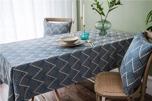 Close-up of waterproof dark blue geometric jacquard tablecloth with matching cushion set