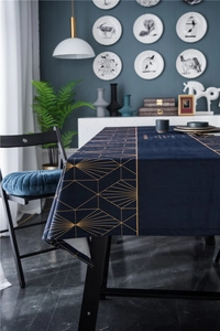 Detailed view of luxury navy velvet tablecloth with golden geometric line patterns