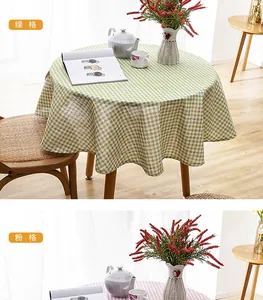 Detail view of round gingham tablecloth with fringe tassels in green and pink patterns