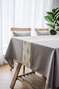 Detail of grey waterproof polyester table runner with yellow diamond geometric pattern