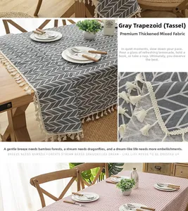 Close-up of thick grey geometric and pink checkered tablecloth with white tassels