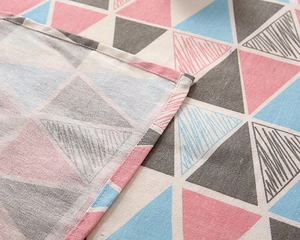 Close-up of the fine edge stitching and geometric triangle pattern on poly-cotton tablecloth