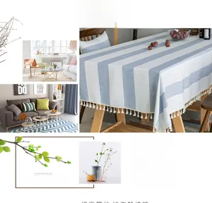Close-up of Nordic style blue and white striped tablecloth with white fringe tassels