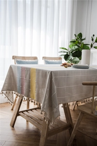 Detailed macro of waterproof linen table runner showing Nordic stripes and tassel fringes