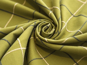 Close-up of green plaid jacquard tablecloth with textured weave and waterproof fabric