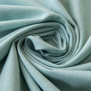 Close-up of mint blue linen texture waterproof tablecloth with elegant spiral fabric folds