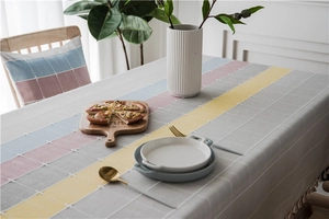 Detail of Nordic plaid table runner with tassels and textured cotton linen fabric