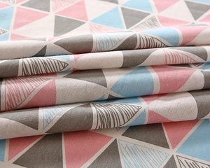 Detailed view of woven fabric texture with pink and blue geometric triangle patterns