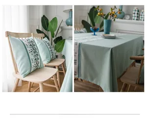 Detail of mint green waterproof faux linen table runner with geometric mosaic borders