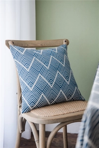 Detailed texture of waterproof blue and white wave pattern square cushion on wooden chair