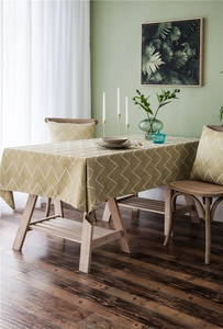 Detail of waterproof jacquard tablecloth with white chevron pattern and matching pillowcase