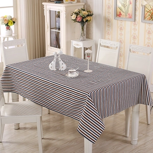 Detail of blue and brown striped polyester-cotton tablecloth on a white dining table