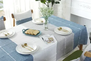 Detail of Nordic jacquard tablecloth with geometric color blocks and cross-stitch embroidery