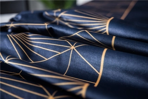 Detail of luxury dark blue velvet fabric with geometric gold line prints and silk texture