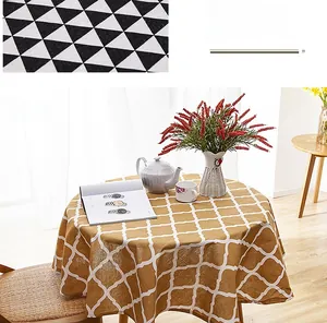 Detail of yellow and white rhombic pattern tablecloth with elegant fringe tassels