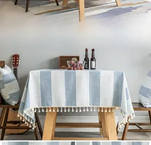 Close-up of blue and white striped cotton linen tablecloth with tassel fringe detail