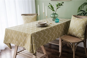 Close-up of olive green herringbone jacquard tablecloth with matching cushion covers