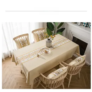Detail of waterproof beige linen tablecloth and matching cushions with geometric patterns