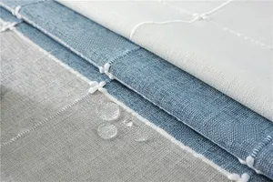 Close-up of waterproof jacquard tablecloth fabric showing quilting detail and water droplets