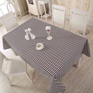 Detail of navy and red striped tablecloth with neat stitching on white dining table