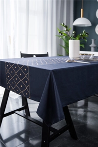 Close-up of luxury velvet tablecloth with gold geometric patterns and modern diamond print