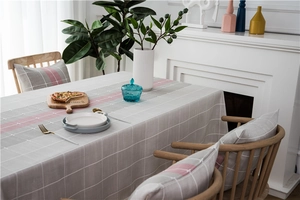 Close-up of geometric striped table runner and matching pillow in Nordic decor