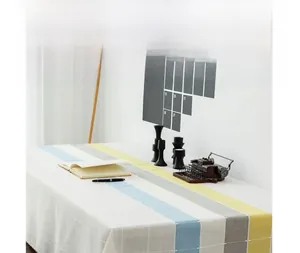 Detail of Nordic striped checkered tablecloth with elegant fringe and cotton linen texture