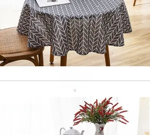 Close-up of grey and white geometric arrow print round tablecloth with fringe edges