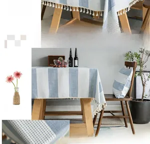Close-up of blue and white striped cotton linen tablecloth with white tassel fringe edges