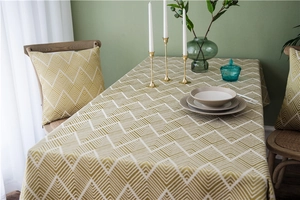 Close-up of yellow and white herringbone jacquard tablecloth in a modern Nordic setting
