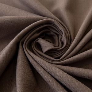Detailed macro view of dark brown linen-textured fabric with thick weave and soft drape