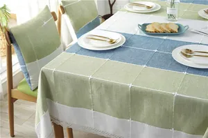 Macro shot of Nordic green plaid tablecloth with floral embroidery and lace borders