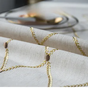 Macro detail of waterproof cotton linen tablecloth with yellow arrow embroidery