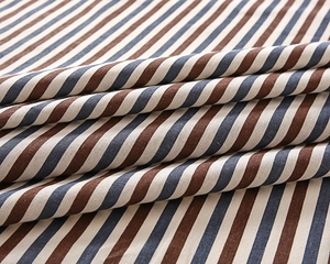 Detailed macro view of blue and brown striped cotton linen tablecloth texture and fabric folding
