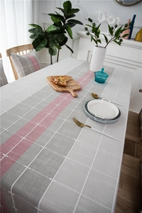 Macro detail of Nordic style plaid table runner showing cotton linen fabric and stitching