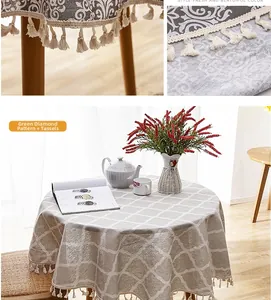 Close-up of green diamond pattern tablecloth with decorative fringe and fabric texture