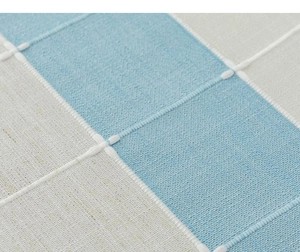 Macro shot of striped cotton linen tablecloth with premium blue and beige checkered weave