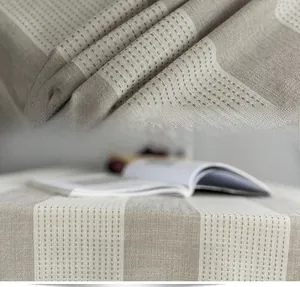 Detailed fabric texture of beige and white striped cotton-linen blend tablecloth