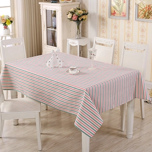 Close-up of rectangular striped tablecloth on a dining table in a cozy home setting