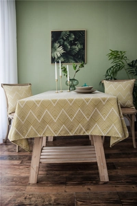 Detail of yellow and beige wave pattern jacquard tablecloth with matching pillow cover