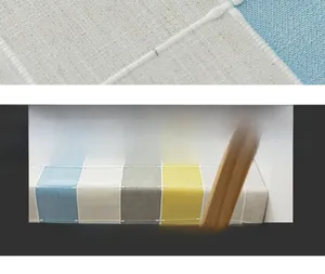 Close-up of geometric striped linen-texture fabric with yellow and blue plaid details