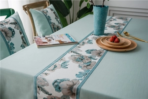 Close-up of waterproof faux linen table runner with elegant floral patterns and texture